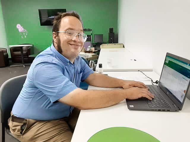 Happy employee working on a computer